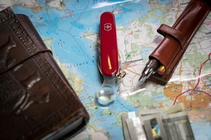 A map with a pen, wallet, and a knife on it